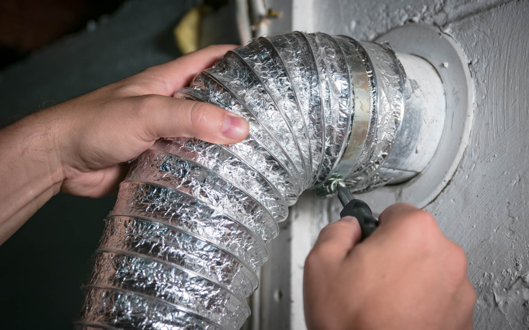 person installing dryer vent tubing