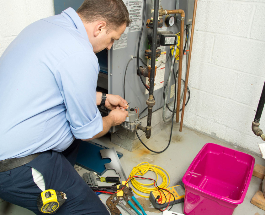 View of a technician working on HVAC parts