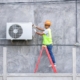 Worker changing parts on HVAC unit