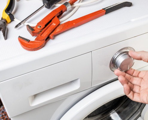 Washing machine repair concept. handyman fix washing appliance