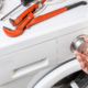 Washing machine repair concept. handyman fix washing appliance