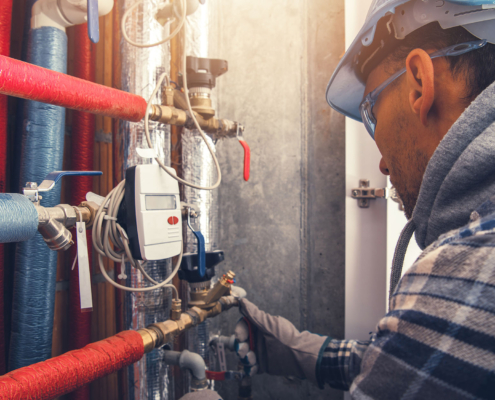 Side view of HVAC technician making changes