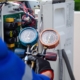 Person checking pressure on HVAC unit