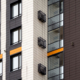 Fragment of a multi-storey house with windows, balconies