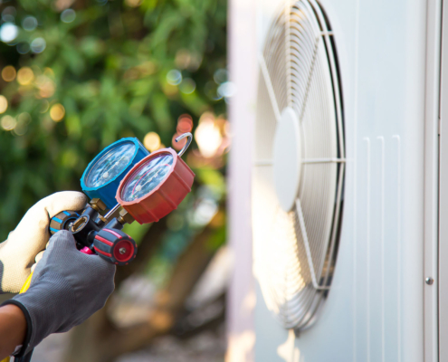 Mechanic air conditioner technician using manifold gauge
